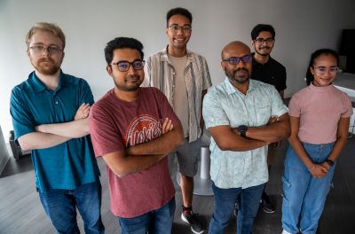 Group photo of students and professor standing